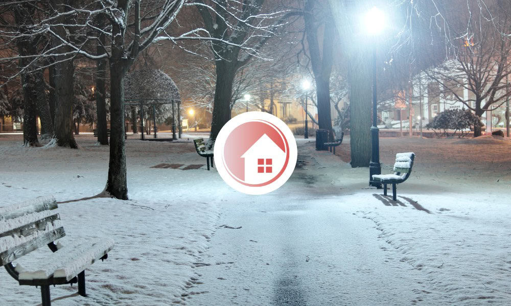 image of a winter background outside, with the Homecarers logo in the centre of the image against a white background.