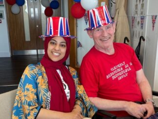 Image shows Hannan with service user Glenn at work