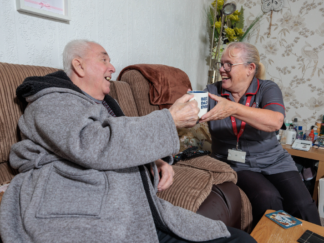 Image shows carer providing home and elderly care to a service user